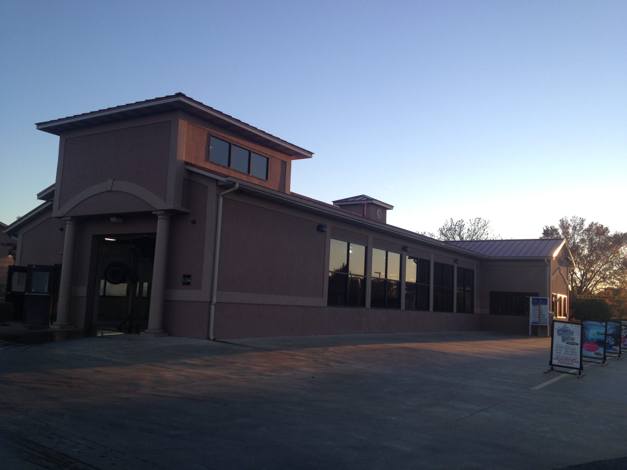 Car wash commercial building with a standing seam metal roof in red