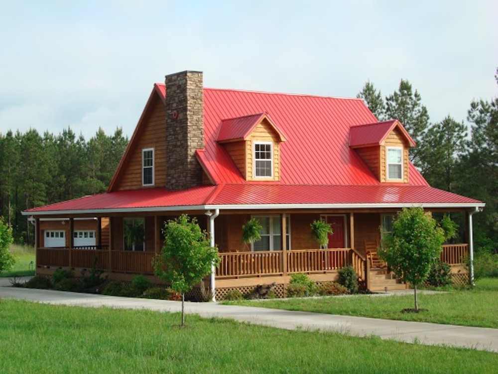 Red metal roof on rustic wood home.