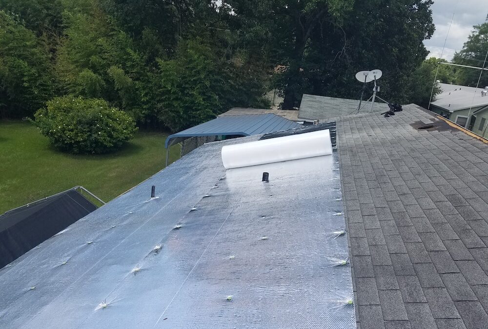 Insulation installed under a metal roof.