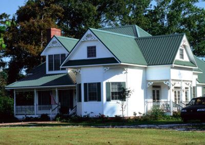 Max Rib R-Panel in Forrest Green on a traditional white house.